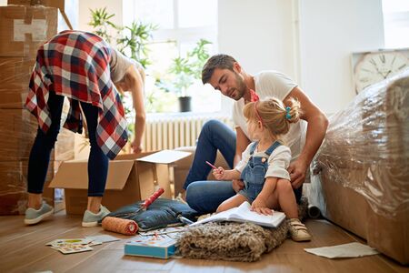 young couple with a toddler girl moving in new homeの写真素材