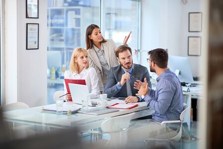 Group of businesspeople presenting ideas to clients at his office