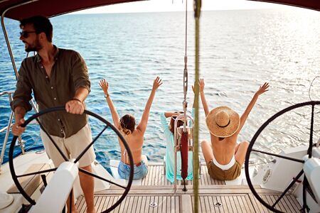 young friends on the luxury boat together enjoy at summer dayの写真素材