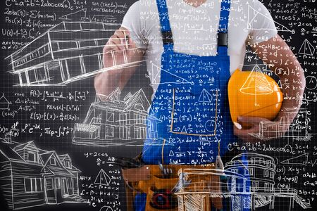 Construction man writing  sketch on transparent wall from of himの写真素材