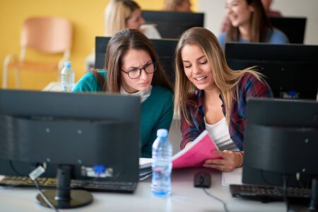 Smiling girl on class with computer on university campusの写真素材