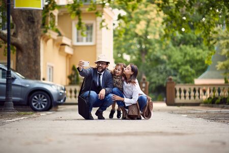 silly family photo in front of schoolの写真素材