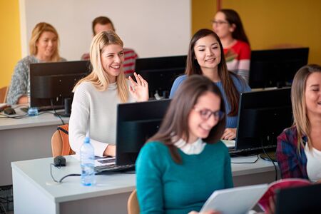 class with young multi-ethnic students on computer on university campusの写真素材
