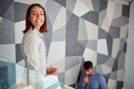 Young businesswoman smiling at the stair at workの写真素材