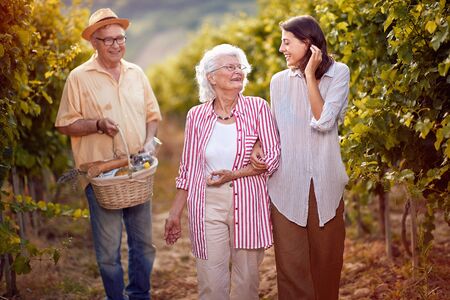 smiling mother and daughter on autumn vineyardの写真素材