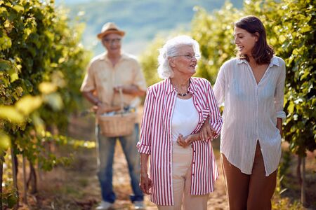 Wine and grapes. Family tradition. Harvesting grapes. smiling mother and daughter on autumn vineyard