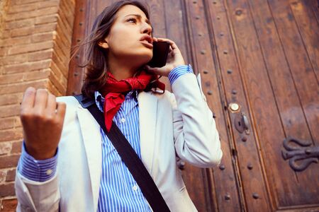 successful modern businesswoman working and talking  at street.