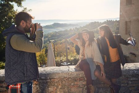Happy friends enjoying a sunny day on travelの写真素材