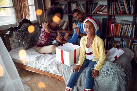 fun and cheerful Christmas.Happy family together with little girl child celebrating Christmas and opening present.の写真素材