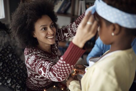 Smiling mather and dauther enjoying in the holidays and celebrating christmas togetherの写真素材