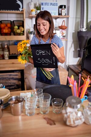 open coffee shop.Smiling woman working at open coffe shop.の写真素材