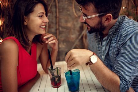 happy young couple on date celebrating Valentines day.  Love and romance . elegant lovers having fun with lights in background. Valentines day concept. closeupの写真素材
