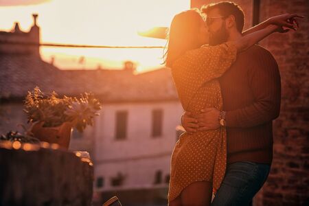 Romantic kiss at  beautiful sunset.Young couple in cheerful love.の写真素材
