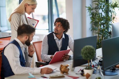 Successful business people and software developers working as a team in office.