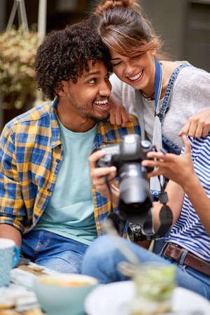 Couple looking together photo in cameraの写真素材