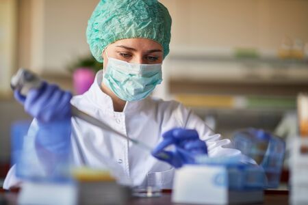 female scientict making research in lab analyzing a new virus. corona virus concept