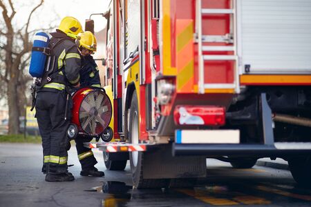 Fireman  pack equipment on the fire truck.firefighter  successfully completed the dangerous...
