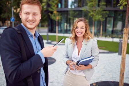Smiling business man and woman meeting outdoor.Young employees  outdoor together.の写真素材