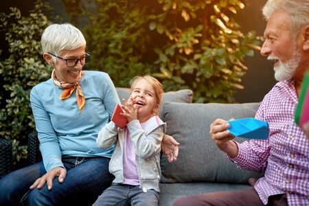 grandparents  having  great time with their  granddaughter, laughing
