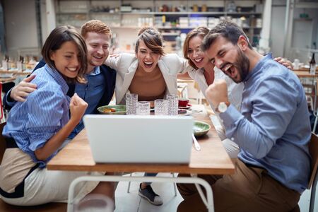 Business People Celebrating Success at the coffee shop together.