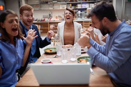 Group of young business people chatting and using laptop in cafe at the coffee shop cafe  talking...