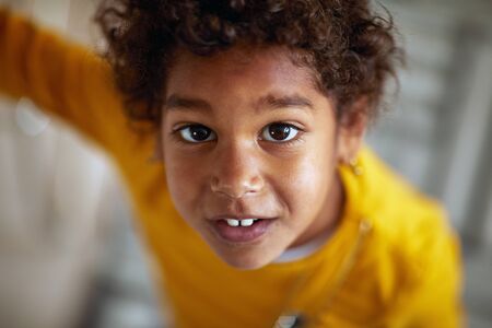portrait of cute afro-american girl.Afro american cute little girl with curly hair.の写真素材