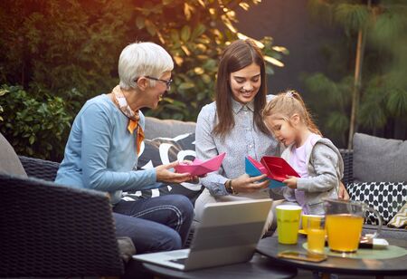 Family laughing in backyard.
Girls with  their smiling mother and grandmother.の写真素材