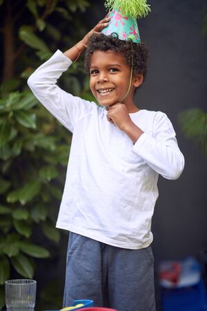 cute afro-american girl.Happy boy with birthday hat.Afro american cute little girl with curly hair.の写真素材