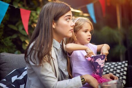 Smiling mother and her child's girl celebrate children birthday partyの写真素材