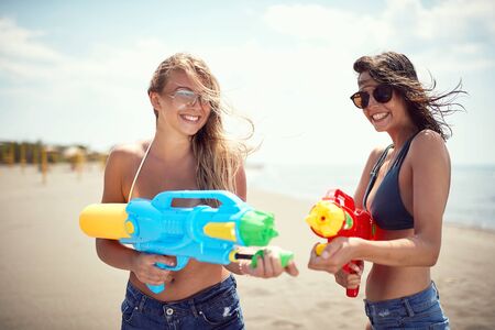 Smiling  young women having fun on the beach.Crazy vacation at the beach in summer holiday.の写真素材