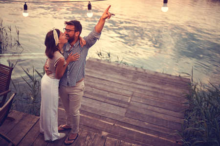 top view of a couple hugging and smiling on the riversideの写真素材