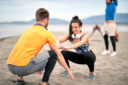 Fitness young man and woman  running along beach.Enjoying at vacation and exercise at the beach.