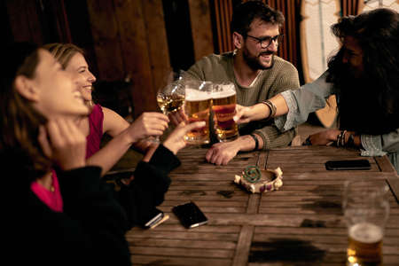 Young friends drinking beer and and having a good time.Happy  People having fun drinking alcoholic.