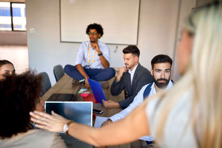 Young colleagues having a casual meeting in the office