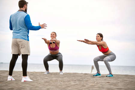 Two woman having personal training class on the beach