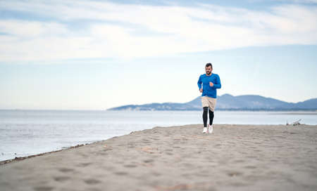 Man jogging on the beach in the morningの写真素材
