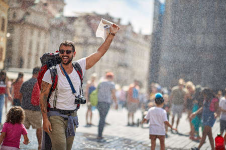Smiling man  traveling and enjoying summer at raining day.の写真素材
