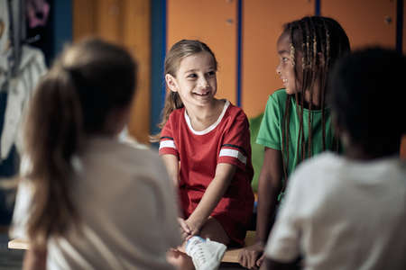 The little soccer teammates waiting for a training in a locker roomの写真素材