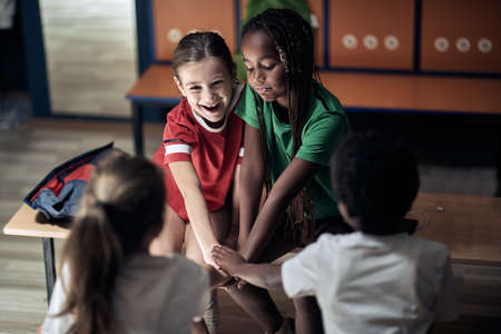 The little soccer teammates in a locker room are excited and ready for a trainingの写真素材