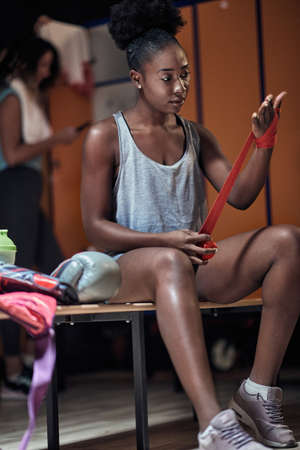 Female boxer in a locker room preparing for a trainingの写真素材