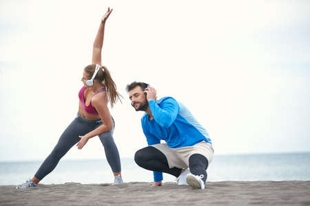 Couple doing fitness on the beach on a beautiful weatherの写真素材