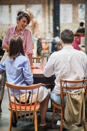A group of cheerful friends relaxed at a cafe