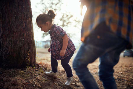 A baby girl exploring the nature on a beautiful autumn dayの写真素材