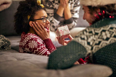 young afro-american female surprised by present from a friends