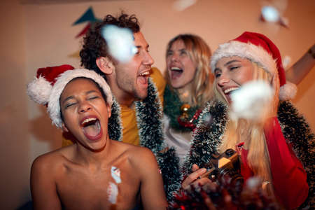 Group of friends having fun on a New Year party at homeの写真素材