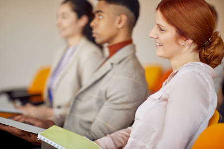 Business people carefully listening to at a meeting in a pleasant atmosphere in a conference hall. People, job, company, business concept.の写真素材