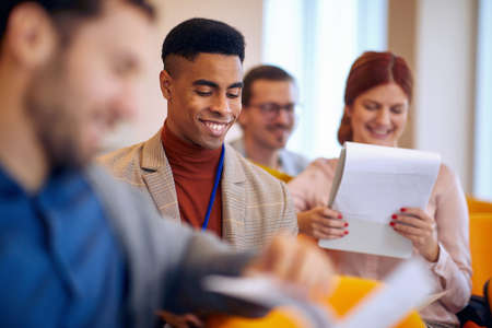 Cheerful business people at a meeting in a pleasant atmosphere in a conference hall. People, job,...