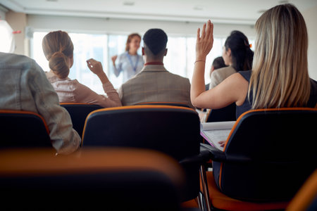 Group of business people asking the lecturer questions in a working atmosphere at seminar. People,...
