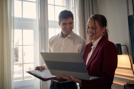 Young modern couple preparing for a business meeting together