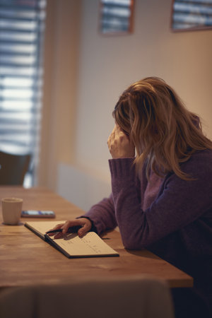 Female writer in s pleasant atmosphere at the kitchen trying to write. Writing, morning, inspirationの写真素材
